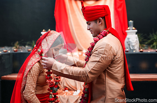 Image of Wedding, marriage and flowers with a couple together in celebration of love at a ceremony. Happy, romance or islamic with a hindi bride and groom getting married outdoor in tradition of their culture