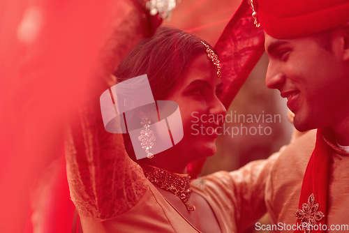 Image of Wedding, marriage and red veil with couple together in celebration of love at a ceremony. Happy, romance or islamic with a hindu bride and groom getting married outdoor in tradition of their culture