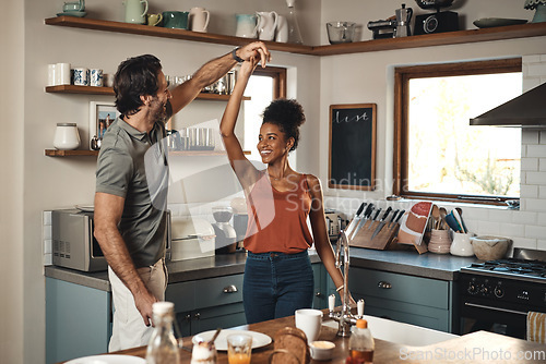 Image of Interracial couple, dance and love in kitchen for romance, fun bonding or holiday together at home. Happy man and woman dancing in joyful happiness for romantic relationship or enjoying weekend house