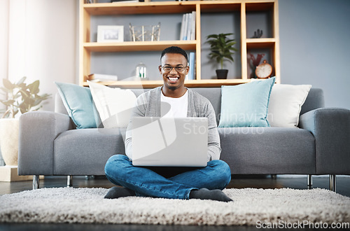 Image of Floor, laptop and portrait of man for home, online research and happy freelancer job in living room with remote work opportunity. Smile, carpet and young african person on computer or technology