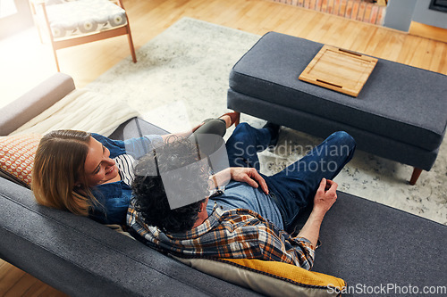 Image of Top view, happy couple and relax on couch in home for quality time, love and care of conversation, discussion and support. Man, woman and talking on sofa for break, bonding and happiness together