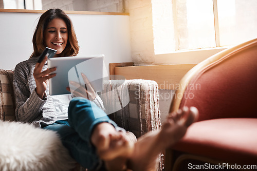 Image of Relax, tablet and credit card with an ecommerce woman sitting on a sofa in the living room of her home. Online shopping, fintech and financial banking with a young female online customer in her house