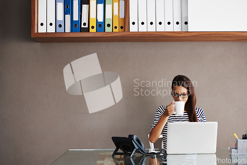 Image of Coffee, laptop and business woman in an office for planning, management and checking email on wall background. Tea, relax and female manager online for project, proposal or creative idea research