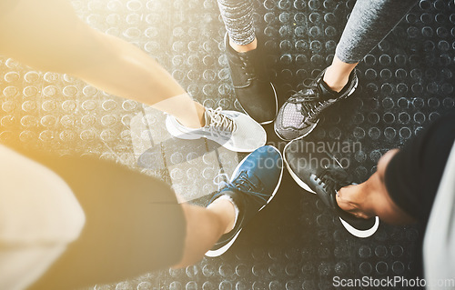 Image of Feet, shoes and training in circle for fitness or exercise with solidarity for workout with teamwork. Group, class and sneakers for cardio with people to support for motivation and a commitment.