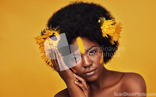 Image of Makeup, sunflower and art with portrait of black woman in studio for beauty, creative or spring. Natural, cosmetic and floral with face of model on yellow background for glow, self love or confidence