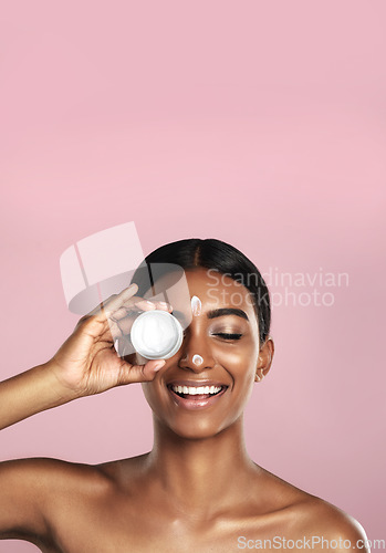 Image of Smile, skincare and woman with cream container in studio isolated on pink background mockup space. Eyes closed, creme cosmetics and Indian female model with lotion, moisturizer product or dermatology