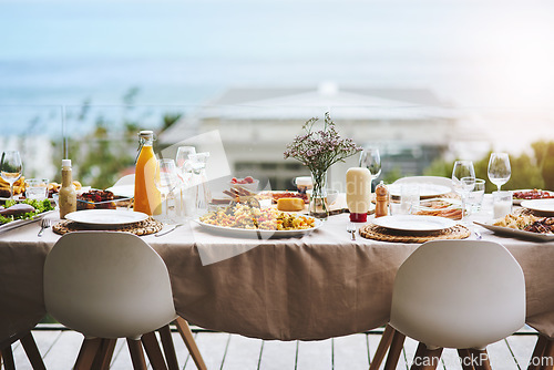 Image of Party, event and table with food, drinks and outdoor for fun, bonding and delicious meal. Chairs, outside and lunch with glasses, juice and social gathering for eating, restaurant and celebration