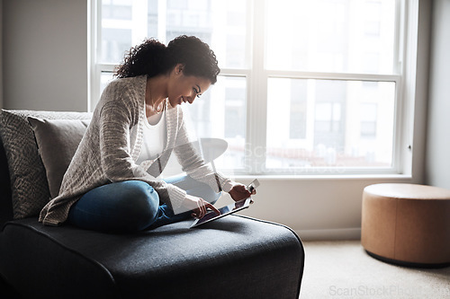 Image of Tablet, credit card and girl on sofa and online shopping in home or ecommerce, paying for retail product and internet store. Latino woman, banking and money for service, digital payment or goods