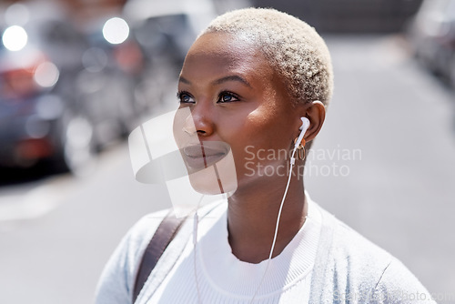 Image of Music, vision and travel with a black woman in the city, thinking about future opportunity during the day. Mindset, idea and tourism with a young female traveler streaming audio in an urban town