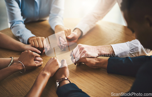 Image of Unity, compassion and people holding hands by a table at a group counseling or therapy session. Gratitude, trust and friends in a circle for praying together for religion, community and connection.