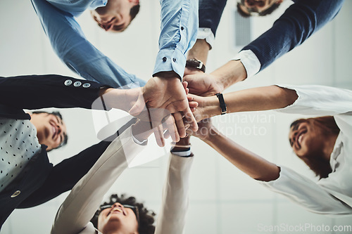 Image of Hands together, business people and solidarity with low angle, support and team huddle with collaboration. Group of employees working in office, teamwork and mission with workforce and hand stack