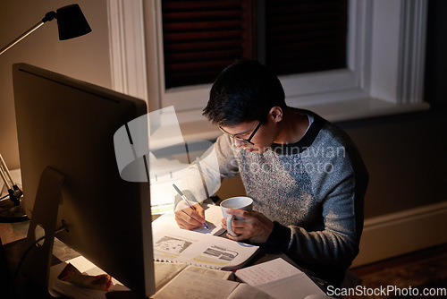 Image of Young, man and student studying at night on a desk computer in a bedroom. College, guy and learning at apartment with coffee to study with technology and the internet for education at university.