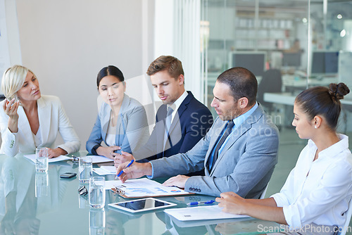 Image of Boardroom, business people and meeting with executive team or management for b2b negotiation or planning. Men and woman at office table with finance paperwork talking about an opinion or solution