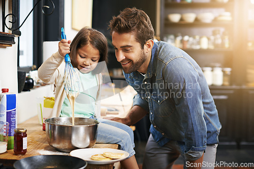 Image of Cooking, smile and father with daughter in kitchen for pancakes, bonding and learning. Food, morning and helping with man and young girl in family home for baking, support and teaching nutrition