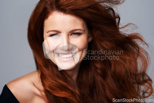 Image of Hair care, ginger and portrait of happy woman with beauty for treatment, wellness and haircare on gray background. Salon, hairdresser and face of female model with red, healthy and natural hairstyle