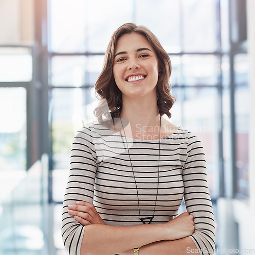 Image of Confidence, crossed arms and portrait of a woman in a office with a happy, good and positive mindset. Happiness, smile and professional corporate female employee standing in the modern workplace.