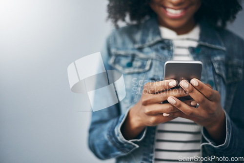 Image of Hands, phone and woman with texting by wall background with smile, mock up space or meme on web chat. Gen z girl, smartphone or happy for blog, post or video on social network app for communication