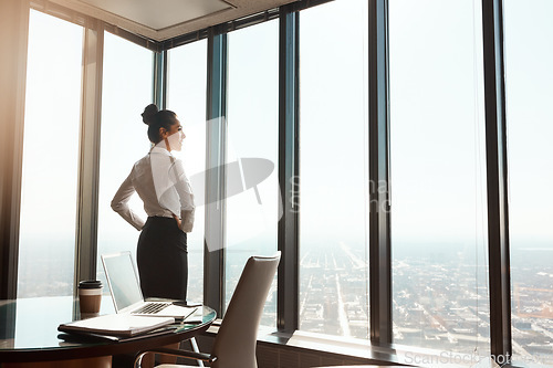 Image of Business woman, office window and thinking of ideas, plan or vision in city building. Professional female entrepreneur person with hands on hips for motivation or inspiration for corporate career