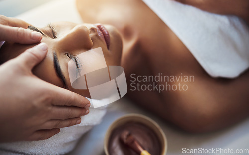 Image of Woman, hands and face massage at spa in relax for skincare beauty treatment on bed at resort. Calm female relaxing with eyes closed or resting in physical therapy, healthy wellness or cosmetic facial