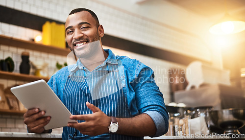 Image of Happy, tablet and portrait of man in cafe for online, digital and african startup. Network, technology and food industry with small business owner in restaurant for barista, waiter and coffee shop