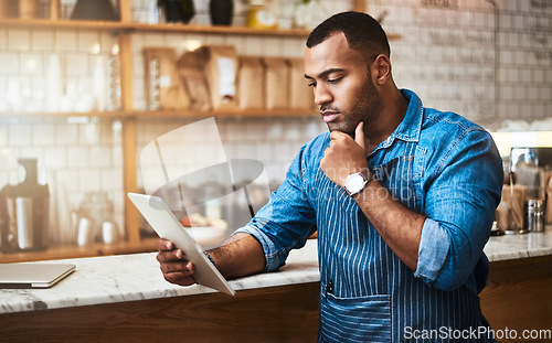 Image of Focus, tablet and thinking with man in coffee shop for online, entrepreneurship and startup. Retail, technology and food industry with small business owner in restaurant for barista, store and cafe