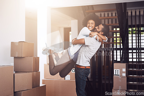 Image of Moving in, couple hug and love with real estate sale and cardboard boxes at new apartment. Happiness, excited and African woman and man bonding together with a smile from mortgage and property deal