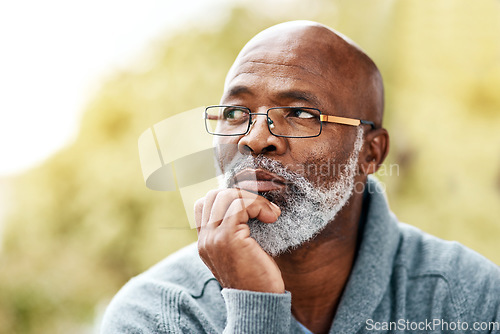 Image of senior, black man and face thinking outdoor in nature to remember memory, idea or vision. Headshot of an elderly male person think or planning future, life insurance or retirement at a park in summer