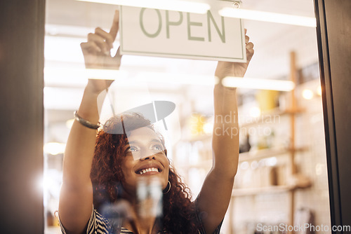 Image of Open, sign and happy woman at window of shop, store and notice of retail shopping time, board and welcome. Small business owner, female worker and advertising opening information to start services