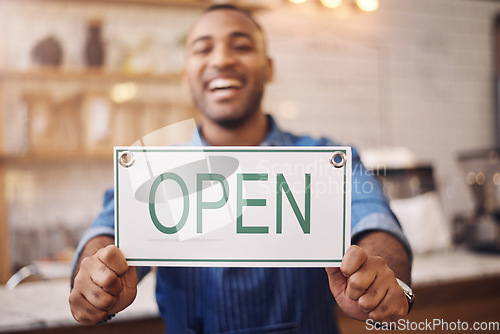 Image of Open, sign and closeup of man in shop, store and advertising notice of retail shopping time, board or trading information. Hands of happy cafe owner with opening banner, welcome and startup services