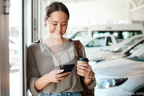 Image of Phone, coffee and woman at a car dealership typing a text message or scrolling on social media. Communication, technology and female person browsing on a mobile app with a cellphone in a showroom.