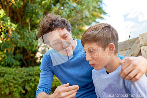 Image of Family, father talking with son in backyard, bonding with love and care, communication and relationship. Man with sad teen boy, help with advice at home and outdoor together with trust and support