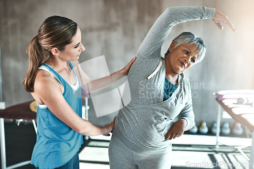 Image of Stretching, help and old woman with personal trainer for fitness, wellness or rehabilitation. Health, workout or retirement with senior patient and female trainer in gym for warm up training