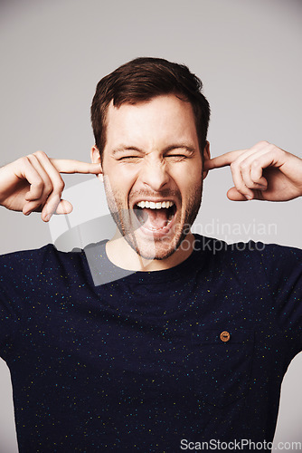 Image of Man, scream and block ears in studio with anger, frustrated face and mental health problem by white background. Isolated guy, model and angry shout with stress, anxiety or noise by gray backdrop