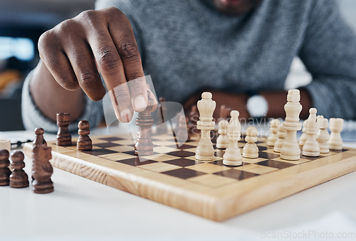 Image of Closeup, hands and man playing chess, strategy and thinking with pieces, concentration and challenge. Zoom, male person and player with a game, hobby and activity for fun, recreation and chessboard