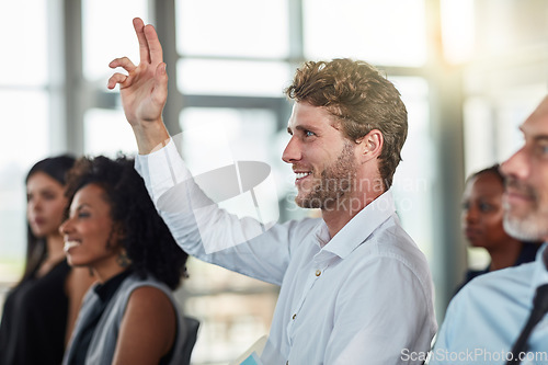 Image of Smile, business man and hands raised for questions at conference, seminar or meeting. Male person, happy and hand up for question, asking or answer, vote and training at workshop presentation event.