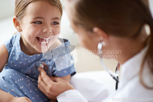 Image of Happy child, girl and stethoscope of doctor for medical consulting, healthy lungs and listening to heartbeat. Face of laughing kid, pediatrician and chest assessment for healthcare analysis in clinic