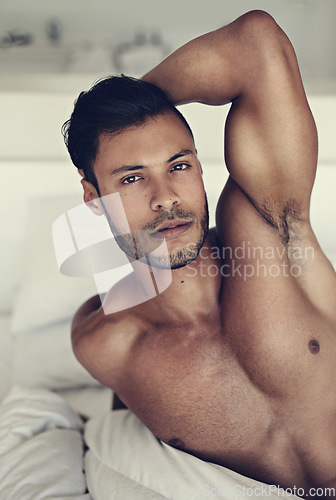 Image of Portrait, body and wake up with a sexy man lying shirtless in the bedroom of his home in the morning. Relax, arm and muscle with a handsome young male model resting topless in bed for sensuality