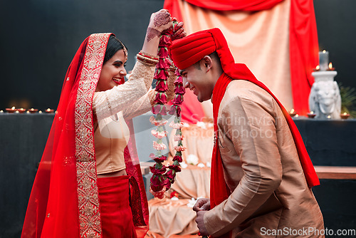 Image of Celebration, young Indian married couple happy and at wedding or special event. Festival or romance, culture or marriage and smiling people with woman putting necklace on man neck with veil.