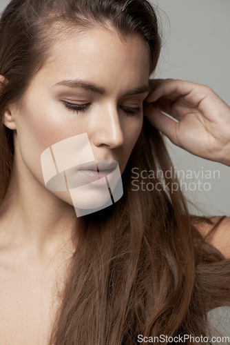 Image of Hair, beauty and serious face of woman in studio for wellness, facial treatment and skincare. Dermatology, luxury spa and female person with natural cosmetics, makeup and beautiful on gray background
