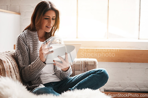 Image of Bank, tablet and credit card with a woman online shopping on a sofa in the living room of her home. Ecommerce, finance payment and fintech banking with a young female online customer in her house
