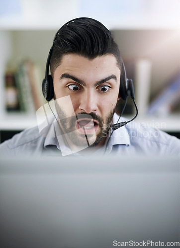 Image of Stressed, frustrated or shocked man in call center reading fake news crisis or mistake with panic in office. Worried virtual assistant, anxiety or surprised consultant frustrated with computer error