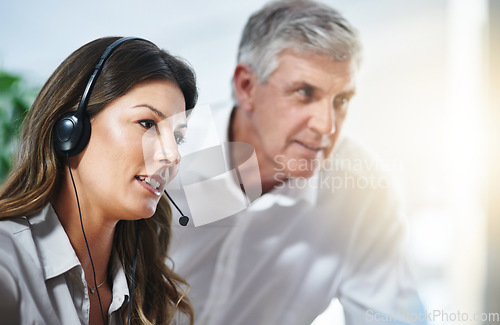 Image of Coaching, woman or senior manager in call center training telemarketing in customer services office. Contact us, coaching or mature mentor teaching an insurance agent on new job advice on computer