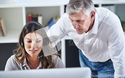Image of Mentor, woman or senior manager in call center training telemarketing in customer services office. Contact us, coaching or mature leader teaching an insurance agent on new job advice on computer
