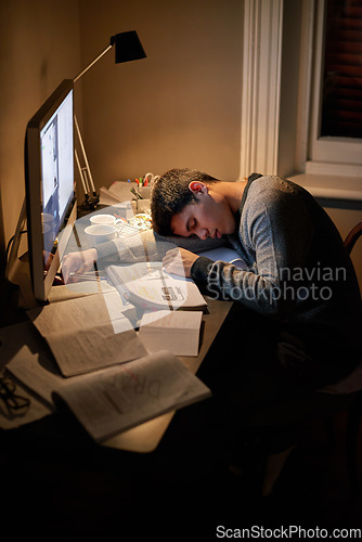 Image of Student, books and sleep or studying late into the night on screen or sleeping on table and reading for examination.Tired, research and male scholar on computer or test paper fatigue at home