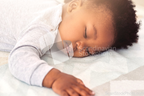 Image of Baby, african and boy sleeping on bed for rest, health and peace for growth, development and relax in family home. Black male infant, tired and sleep in bedroom with fatigue, quiet and calm in house