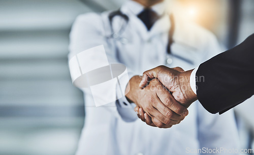 Image of Closeup, doctor and man with handshake, consultation and partnership for healthcare development, growth and agreement. Zoom, medical professional and patient with greeting, shaking hands and wellness