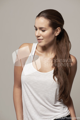 Image of Fashion, casual and profile of a woman in a studio with a trendy, stylish and apparel outfit. Happy, smile and female model with cool style, long hair and positive mindset isolated by gray background