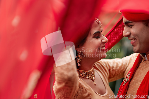 Image of Celebration, young Indian married couple and dancing happy together. Happiness or commitment, love with relationship or marriage and smiling people dance at ceremony or special event with sari