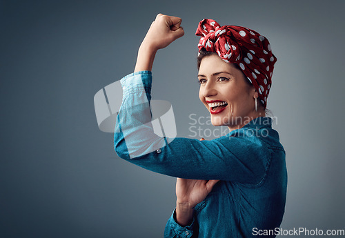 Image of Strong, flexing muscle and happy girl in studio for support, women power and pinup fashion. Female person thinking and laughing for bicep on grey background for motivation, freedom and vintage mockup