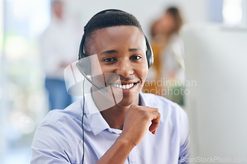 Image of Virtual assistant, portrait or happy black man in call center consulting or talking at customer services. Communication, friendly smile or face of sales agent on mic in telemarketing or telecom desk